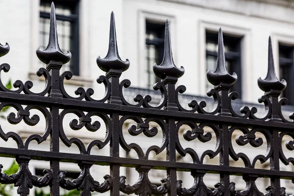 Spiked Iron Fence by White Building — Stock Photo, Image