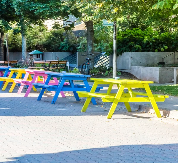 Colorful Picnic Tables on Cobblestone Street — Stock Photo, Image