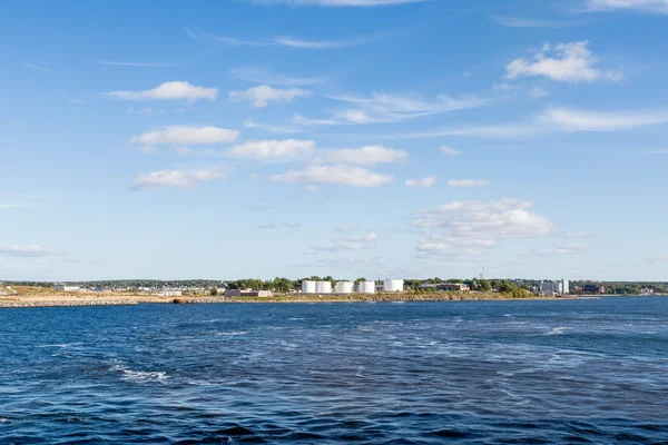 Serbatoi di petrolio bianco tra cielo blu e mare — Foto Stock