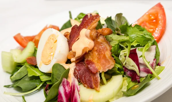 Bacon et oeuf sur salade d'épinards — Photo