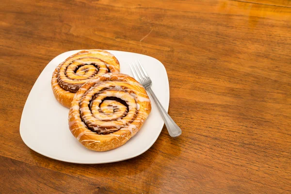 Two Cinnamon Rools on Square Plate with Fork — Stock Photo, Image