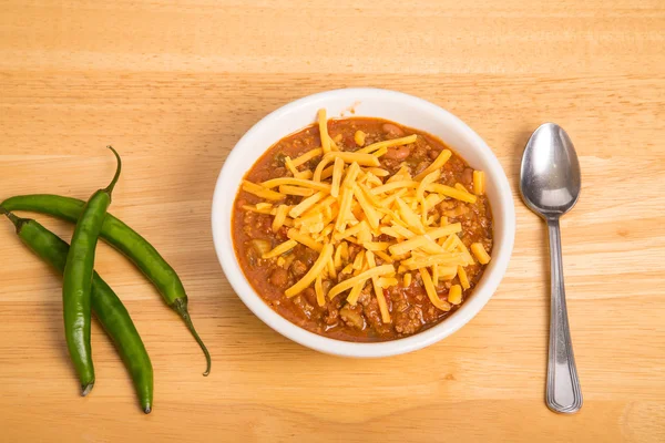 Bowl of Chili with Three Cayenne Peppers