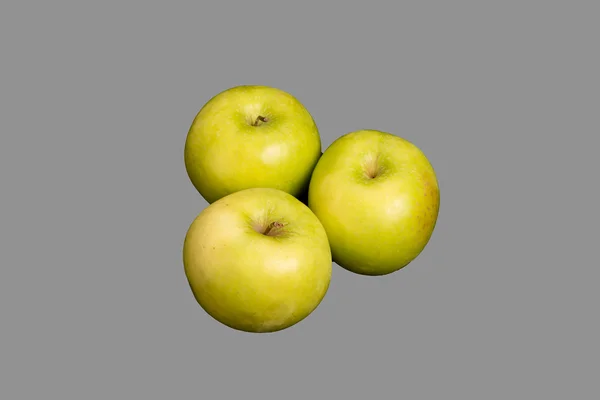 Tre granny smith-äpplen på grå bakgrund — Stockfoto