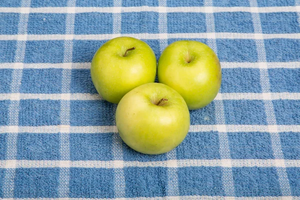 Three Granny Smith Apples on Blue Plaid Towel — Stock Photo, Image