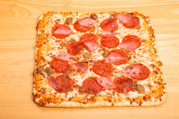 Square Pepperoni Sausage and Ham Pizza on Wood Table — Stock Photo, Image