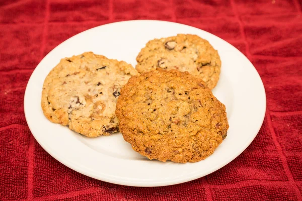 Three Cookies on White Plate and Red Towel — Stock Photo, Image