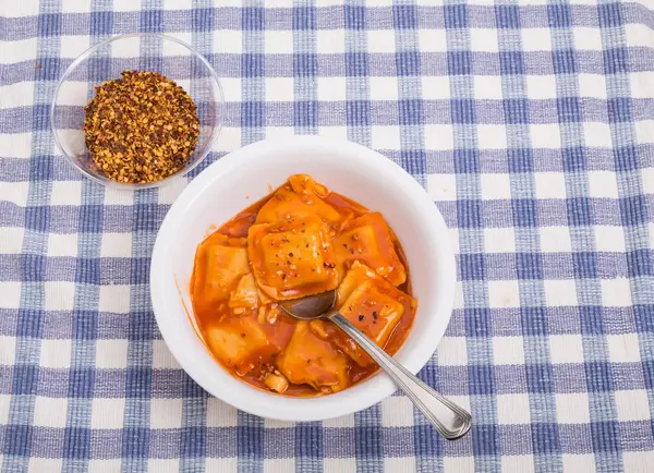 Ravioli in kom met rode peper vlokken — Stockfoto