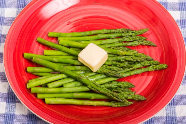 Green Asparagus on Red Plate with Butter — Stock Photo, Image