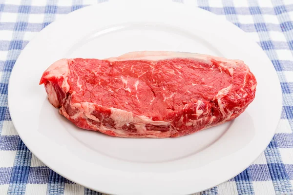 Raw Strip Steak on White Plate — Stock Photo, Image