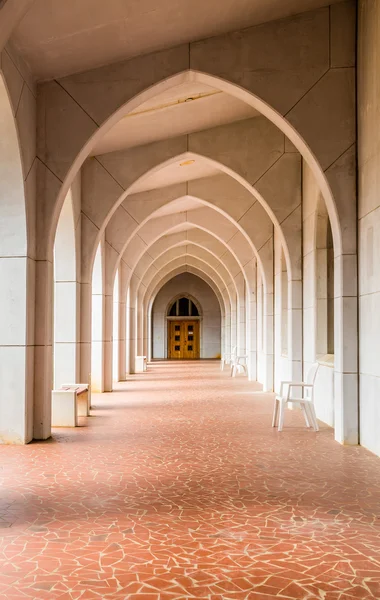 Chair by Arches Over Tile Walkway — Stock Photo, Image
