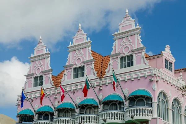 Flags and Green Awnings on Pink Stucco — Stock Photo, Image