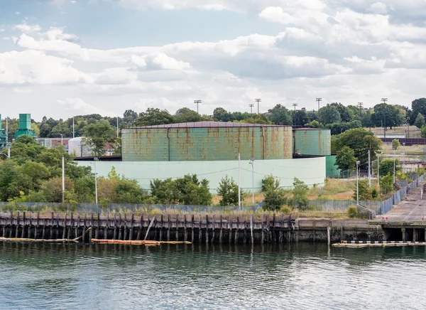 Green Industrial Tanks at Edge of Bay — Stock Photo, Image