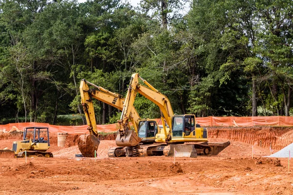 Três máquinas de construção amarelas — Fotografia de Stock