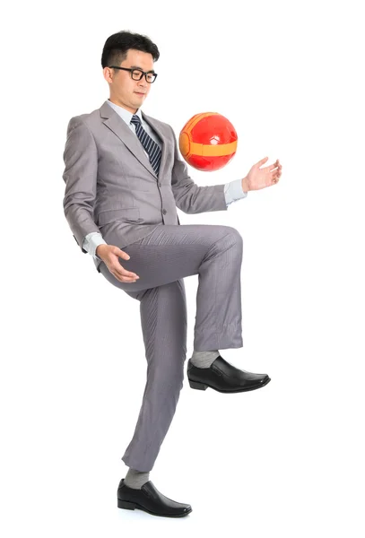 Asian businessman playing soccer — Stock Photo, Image