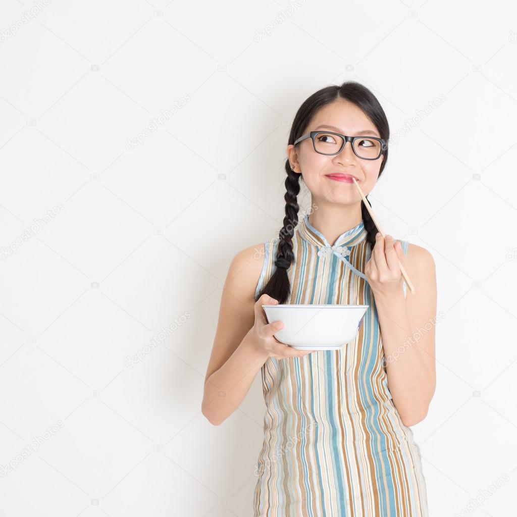 Asian Chinese woman eating