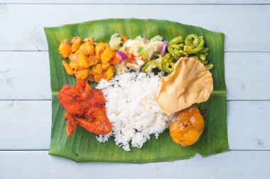 Indian banana leaf rice on table clipart