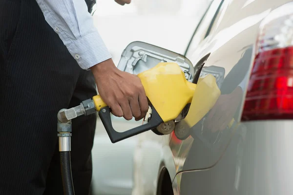 Pumping gasoline fuel at gas station — Stock Photo, Image