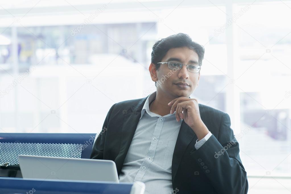 Indian business man having a thought at airport