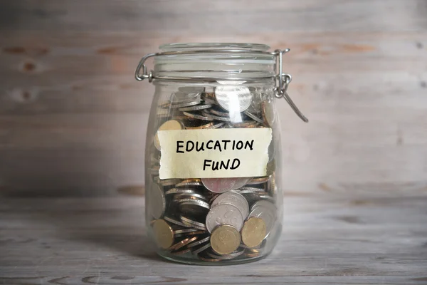 Money jar with education fund label. — Stock Photo, Image