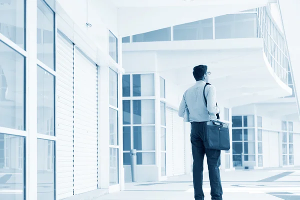 Businessman walking through office building. — Stock Photo, Image