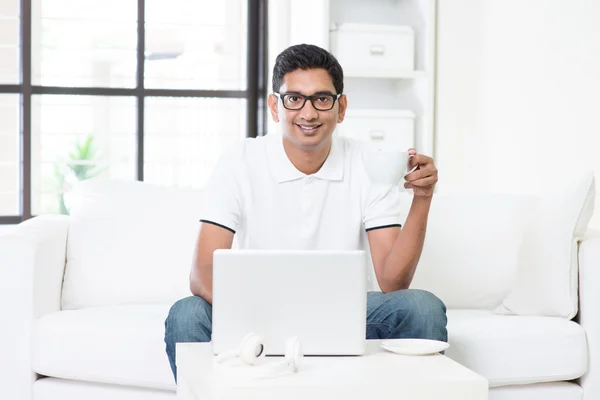 Indian male using computer at home. — Stock Photo, Image