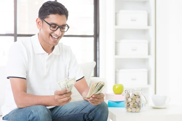 Happy Indian guy counting money — Stock Photo, Image