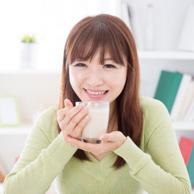 Asian female drinking soy milk