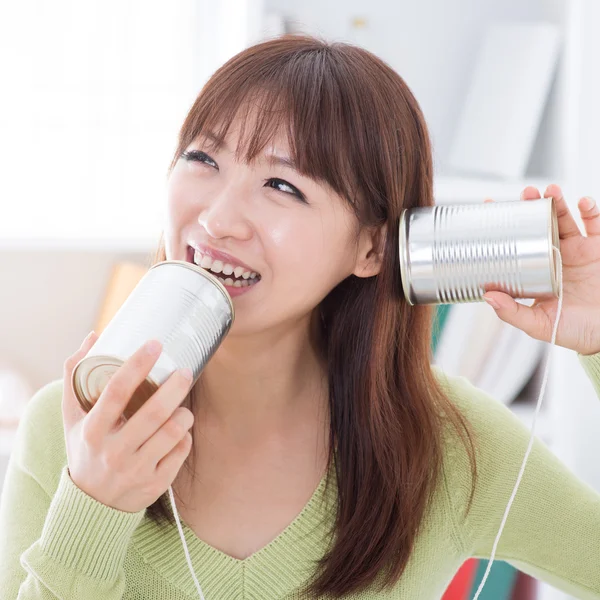 Asian girl and Communication cans — Stok fotoğraf