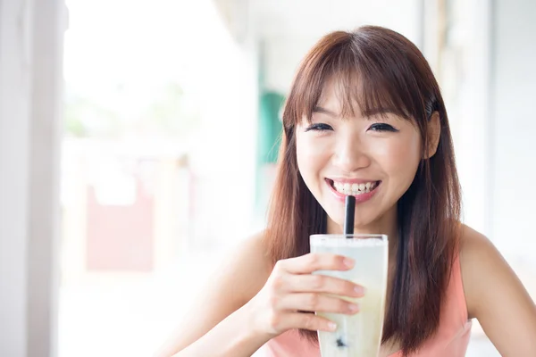 Woman drinking beverage at cafe — Stok fotoğraf