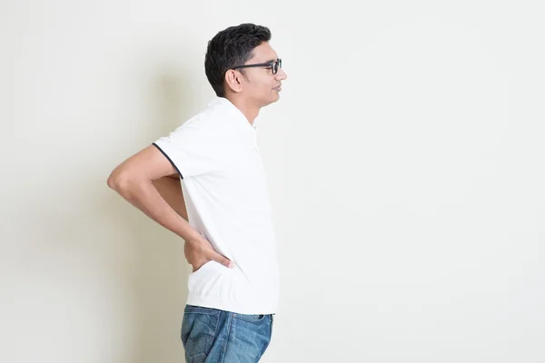 Indian guy with back pain — Stock Photo, Image