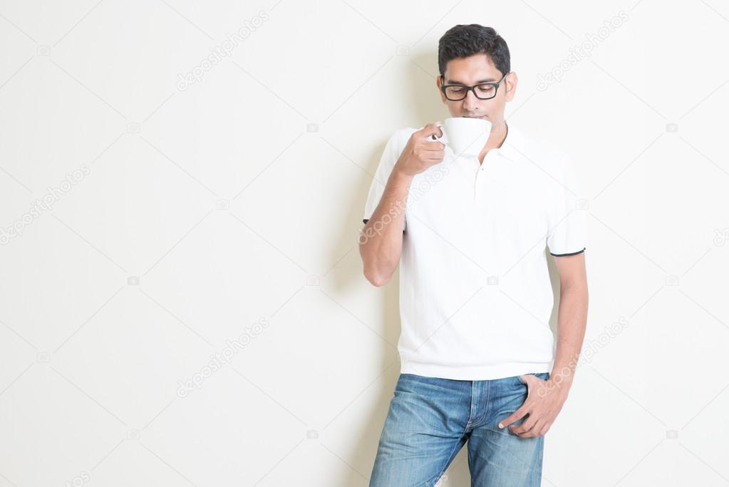 Indian guy drinking coffee — Stock Photo © szefei 77897608