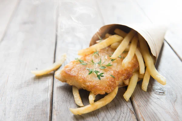 Fish and chips wrapped in paper cone — Stock Photo, Image