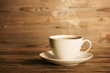 Steaming hot coffee in white mug
