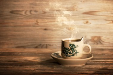 Steaming traditional Chinese coffee in vintage mug and saucer 