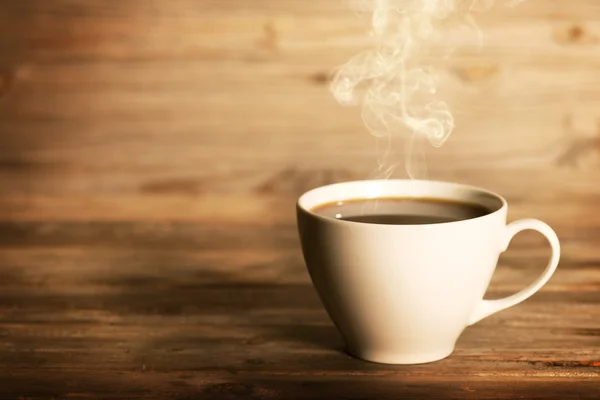 Steaming coffee in white mug — Stock Photo, Image