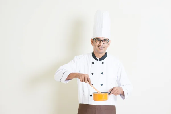 Indiano masculino chef no uniforme cozinhar alimentos — Fotografia de Stock