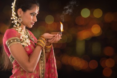Indian girl hands holding diwali lights