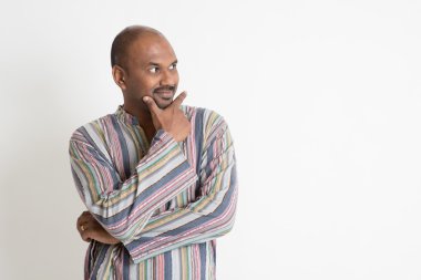 Mature casual Indian man thinking