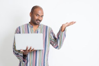 Indian man using computer and showing something