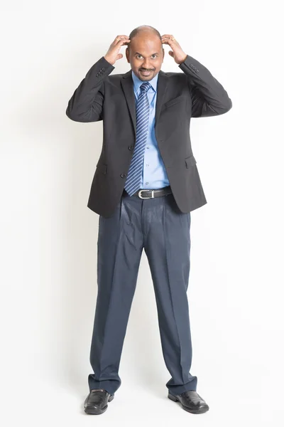 Full length mature Indian businessman scratching head — Stock Photo, Image