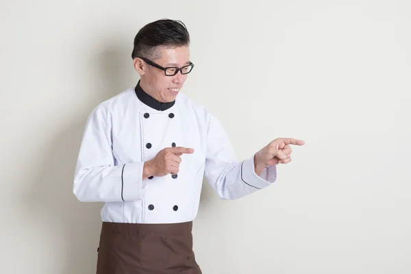 Mature Asian Chinese chef pointing — Stock Photo, Image