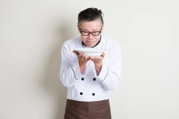 Mature Asian Chinese chef smelling aroma — Stock Photo, Image