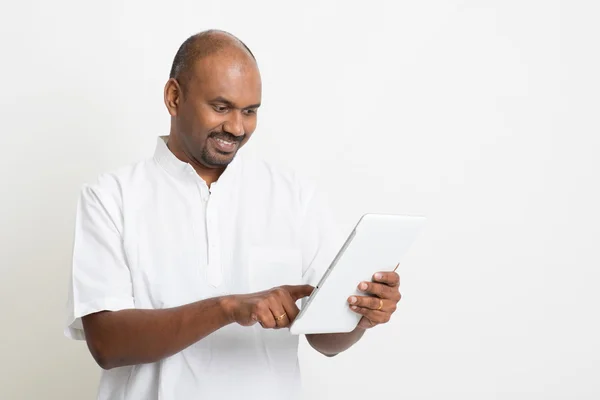 Mature casual business Indian man using tablet pc — Stok fotoğraf