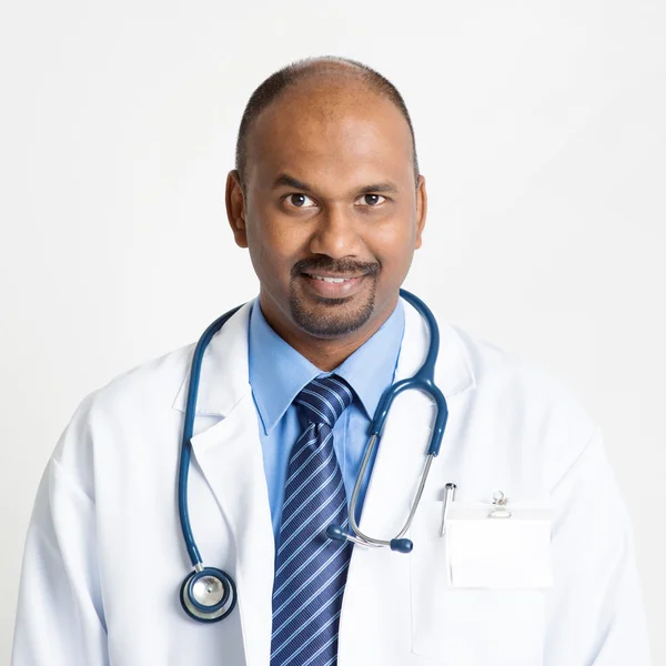 Mature Indian doctor smiling — Stok fotoğraf