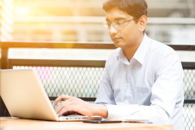 Indian businessman using laptop computer