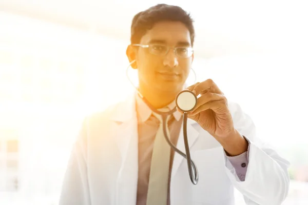 Asian Indian medical doctor holding stethoscope — 图库照片