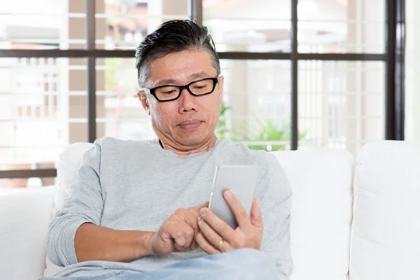 Mature Asian man using smartphone — Stok fotoğraf