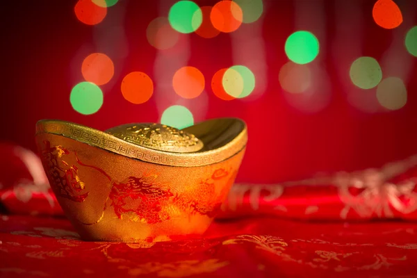 Chinese New Year decorations gold ingot on red background — Stock Photo, Image