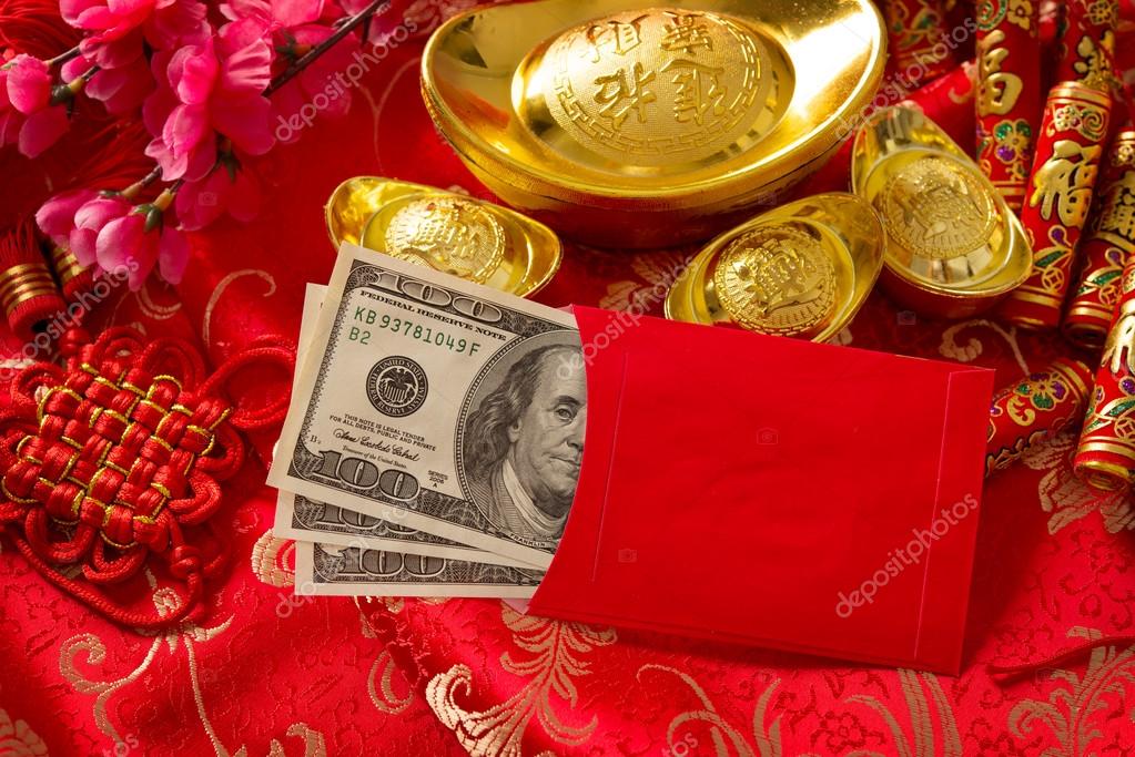 Chinese new year red envelope with dollars inside Stock Photo by