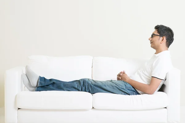 Asian man resting and daydream on couch — Stock Photo, Image